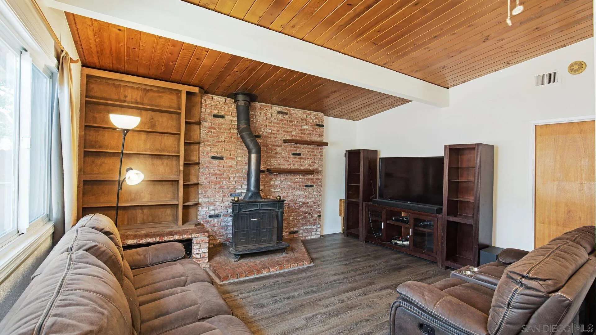 9243 Los Coches Road Lakeside, CA 92040 - Photo 8 of 30 a living room with furniture a flat screen tv and a fireplace