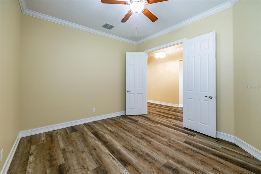 16122 Cedar Key Drive Wimauma, FL 33598 - Photo 11 of 98 a view of room with wooden floor and fan