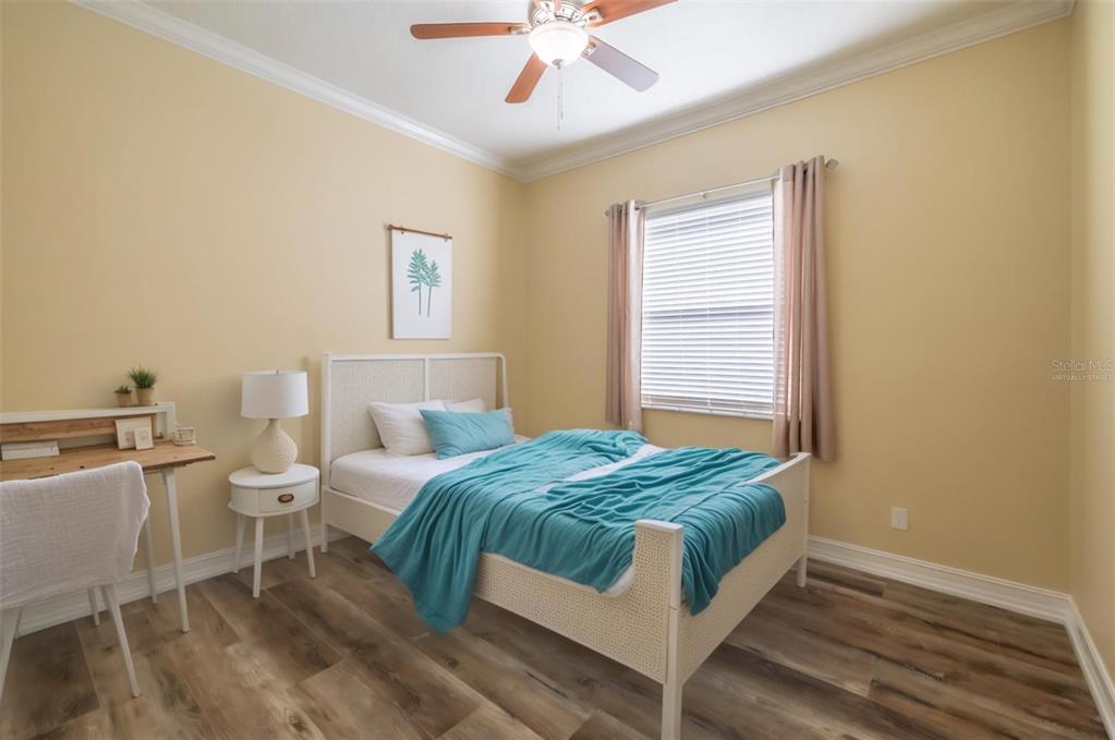 16122 Cedar Key Drive Wimauma, FL 33598 - Photo 13 of 98 a bedroom with a bed and a chandelier