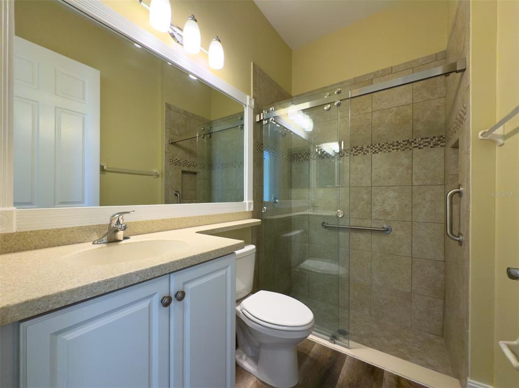 16122 Cedar Key Drive Wimauma, FL 33598 - Photo 16 of 98 a bathroom with a sink a toilet and shower