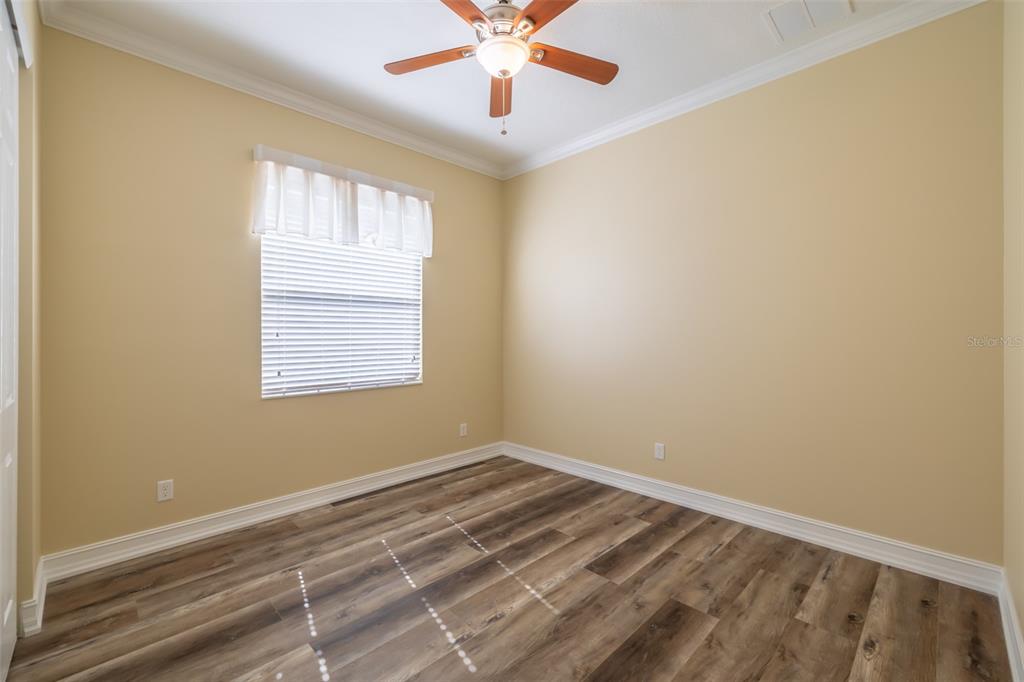 16122 Cedar Key Drive Wimauma, FL 33598 - Photo 17 of 98 a view of a room with a window and a ceiling fan