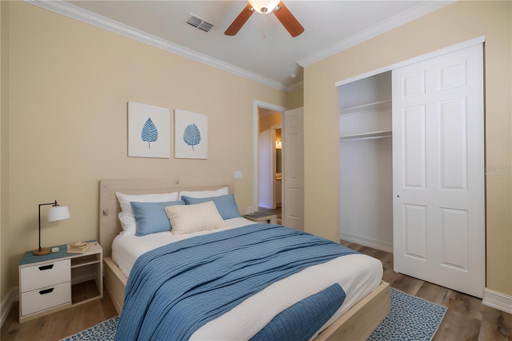 16122 Cedar Key Drive Wimauma, FL 33598 - Photo 18 of 98 a bedroom with a bed and a lamp