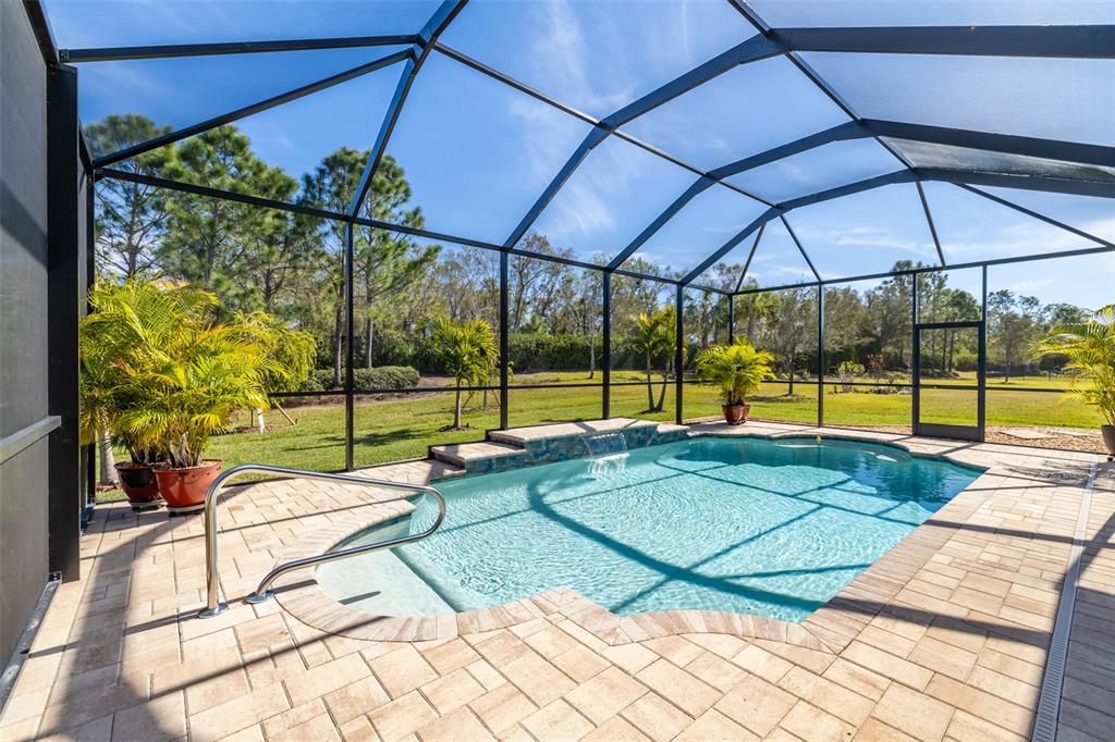 16122 Cedar Key Drive Wimauma, FL 33598 - Photo 2 of 98 a view of a swimming pool with a porch