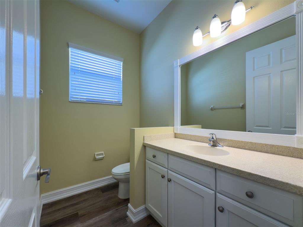 16122 Cedar Key Drive Wimauma, FL 33598 - Photo 21 of 98 a bathroom with a sink a toilet and a mirror