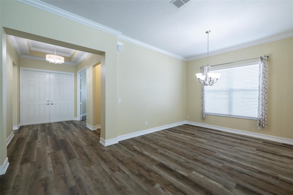16122 Cedar Key Drive Wimauma, FL 33598 - Photo 22 of 98 a view of an empty room with wooden floor and a window