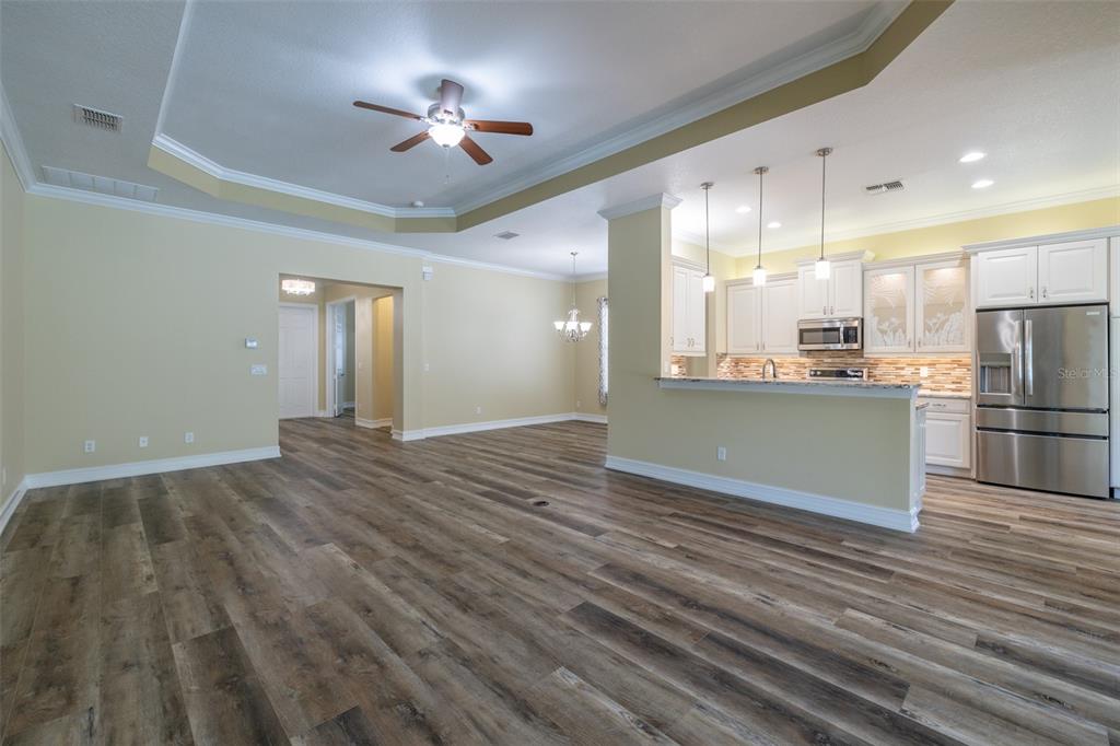 16122 Cedar Key Drive Wimauma, FL 33598 - Photo 23 of 98 a view of a kitchen with wooden floor and a kitchen