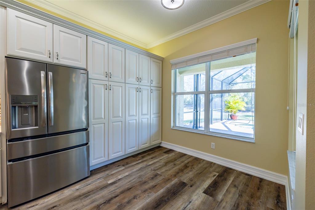 16122 Cedar Key Drive Wimauma, FL 33598 - Photo 28 of 98 a view of a kitchen with wooden floor and electronic appliances