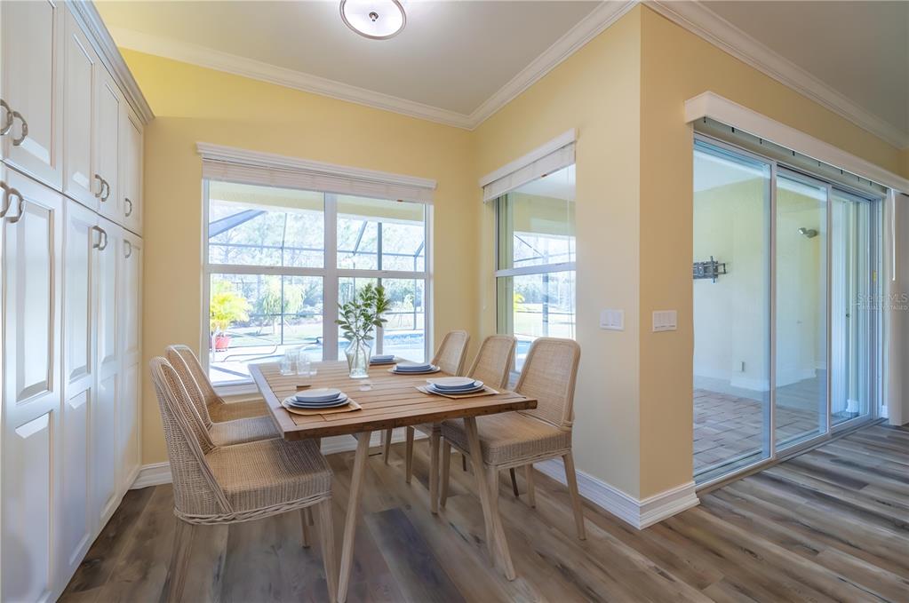 16122 Cedar Key Drive Wimauma, FL 33598 - Photo 29 of 98 a view of a dining room with furniture window and wooden floor