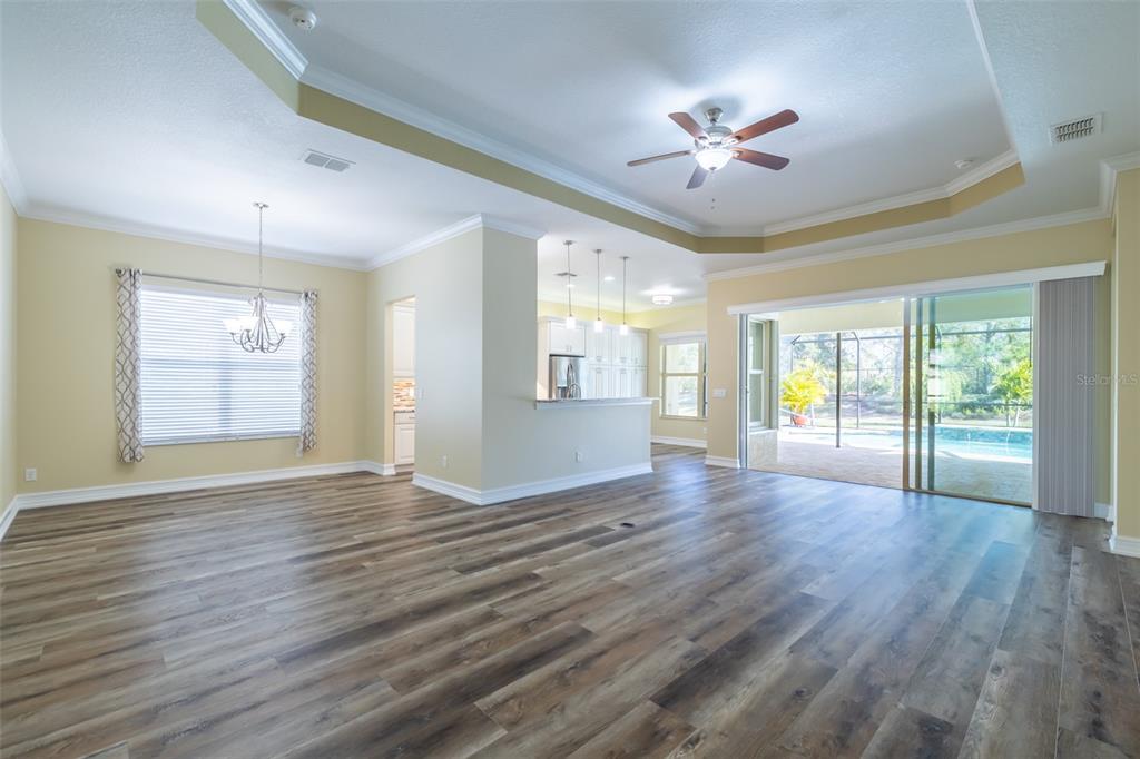 16122 Cedar Key Drive Wimauma, FL 33598 - Photo 33 of 98 a view of an empty room with wooden floor and a window