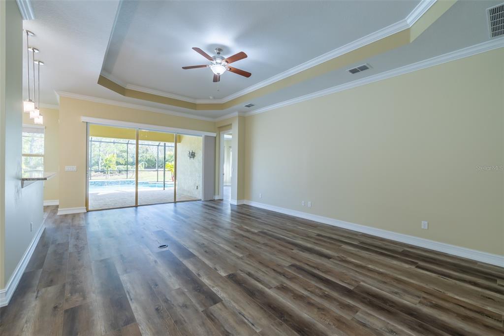 16122 Cedar Key Drive Wimauma, FL 33598 - Photo 35 of 98 a view of empty room with wooden floor and fan