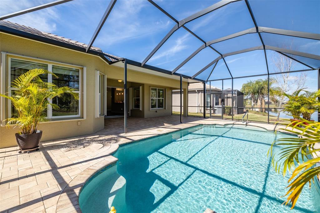 16122 Cedar Key Drive Wimauma, FL 33598 - Photo 41 of 98 a view of a patio with table and chairs under an umbrella