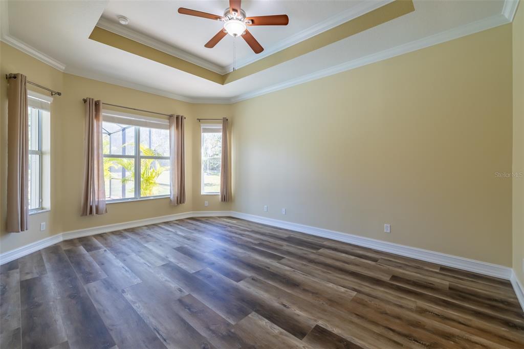 16122 Cedar Key Drive Wimauma, FL 33598 - Photo 46 of 98 a view of an empty room with wooden floor and a window