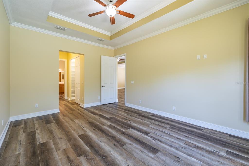 16122 Cedar Key Drive Wimauma, FL 33598 - Photo 47 of 98 wooden floor in an empty room with a window