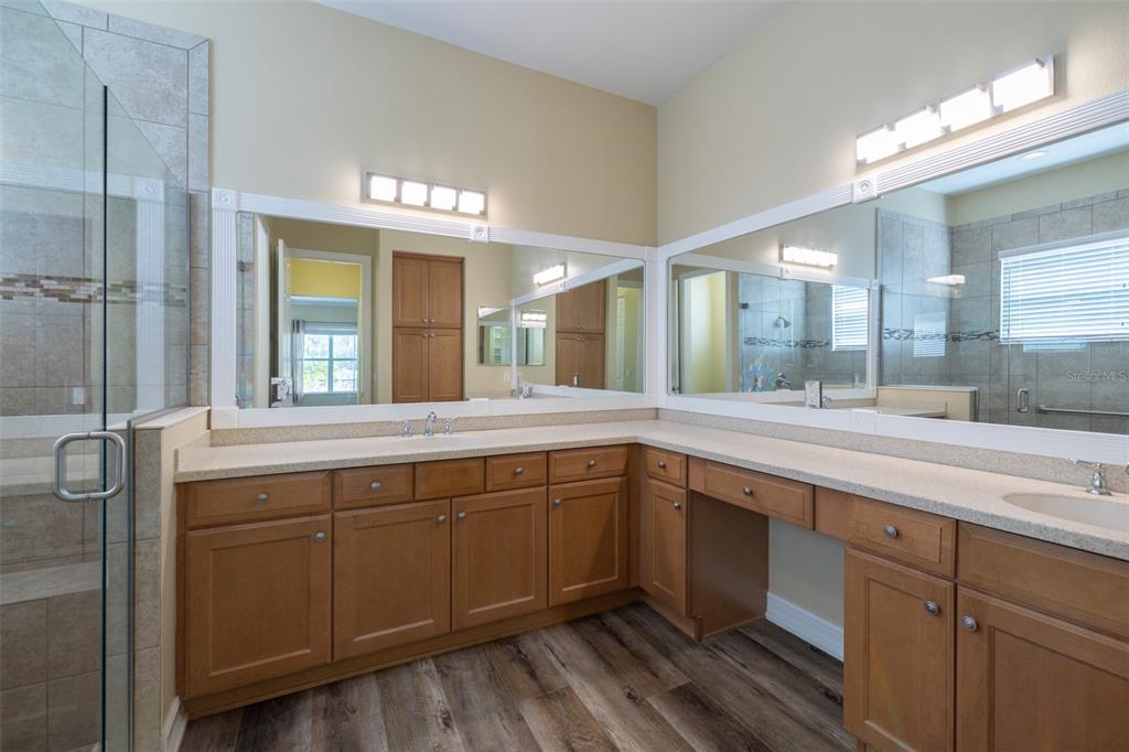 16122 Cedar Key Drive Wimauma, FL 33598 - Photo 49 of 98 a spacious bathroom with a double vanity sink and a mirror