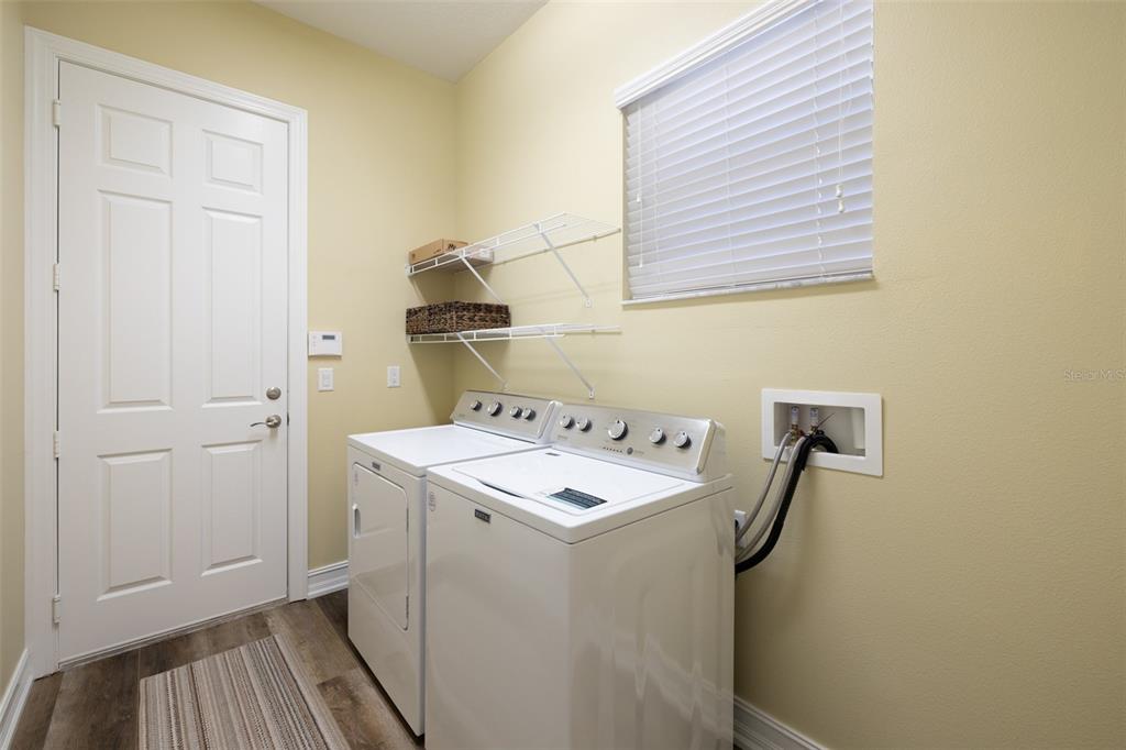 16122 Cedar Key Drive Wimauma, FL 33598 - Photo 52 of 98 a bathroom with a sink and mirror