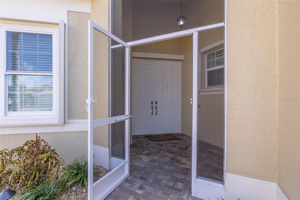 16122 Cedar Key Drive Wimauma, FL 33598 - Photo 6 of 98 a bathroom with a glass shower door and a window