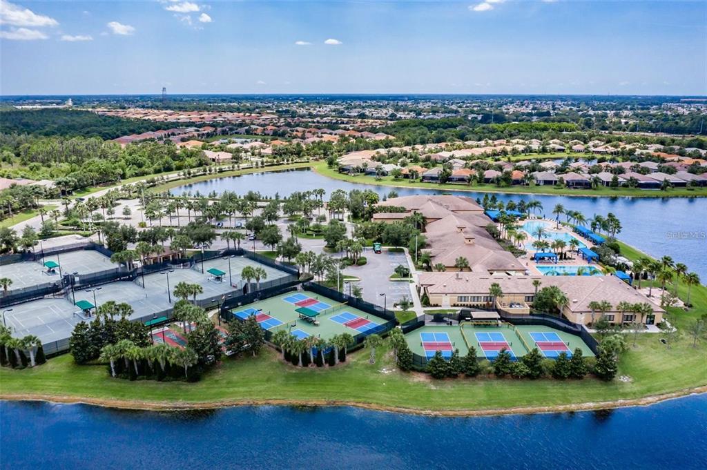 16122 Cedar Key Drive Wimauma, FL 33598 - Photo 61 of 98 an aerial view of multiple house with outdoor space lake view and trees