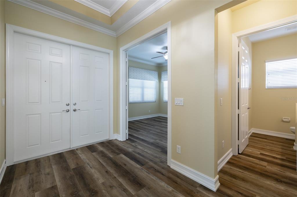 16122 Cedar Key Drive Wimauma, FL 33598 - Photo 9 of 98 a view of a hallway with wooden floor and closet