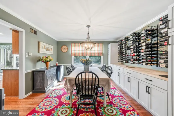 a large kitchen with a table chairs refrigerator and cabinets