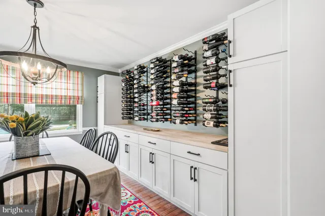 a kitchen with granite countertop wooden floors stainless steel appliances a sink and a window