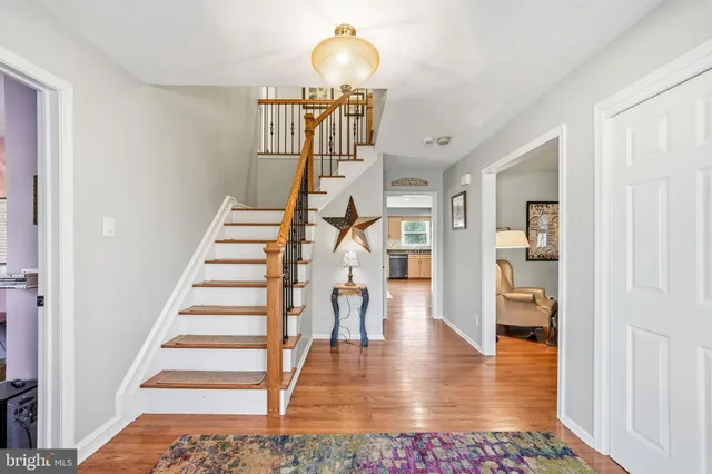 a bedroom with a large bed and flat tv screen on dresser