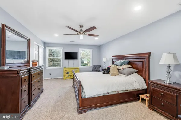 a spacious bathroom with a granite countertop sink toilet and shower