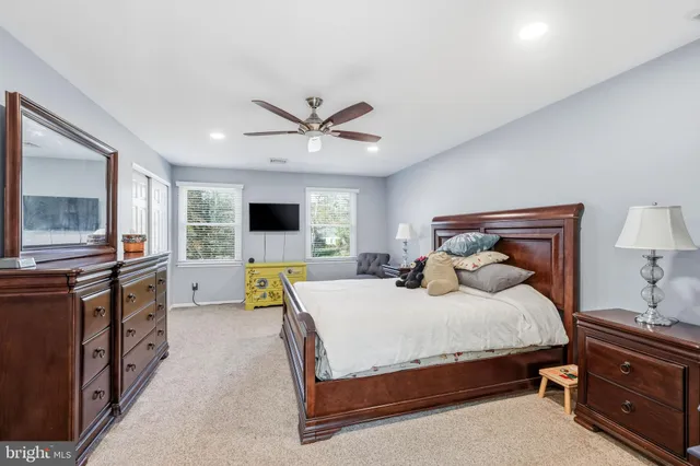 a spacious bathroom with a granite countertop sink toilet and shower