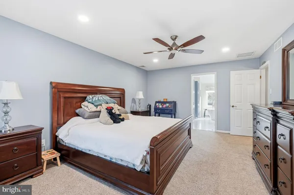 a large tub sitting in a bathroom next to a window