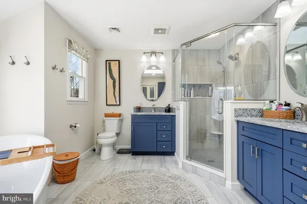 a bathroom with a bathtub and shower