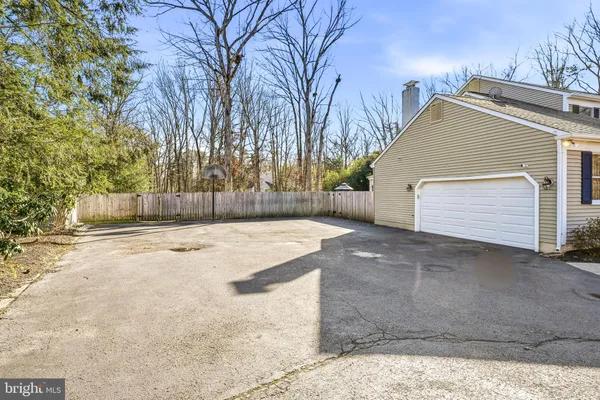 a front view of a house with a yard and a garden