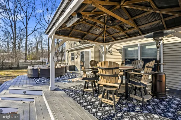 a view of swimming pool with large trees and wooden fence