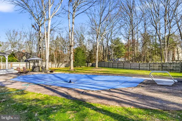 a swimming pool with outdoor seating and yard