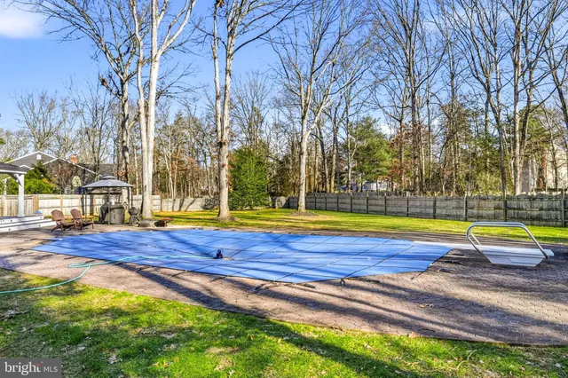 a swimming pool with outdoor seating and yard