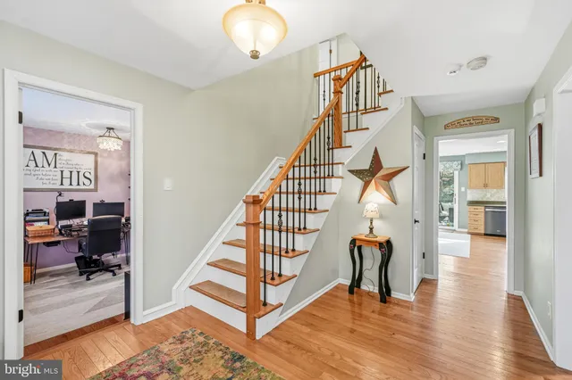 a view of entryway livingroom and hall with wooden floor