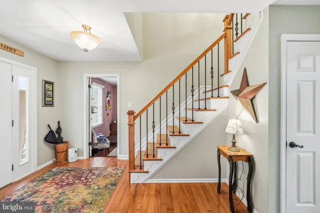 a view of entryway and hall with wooden floor