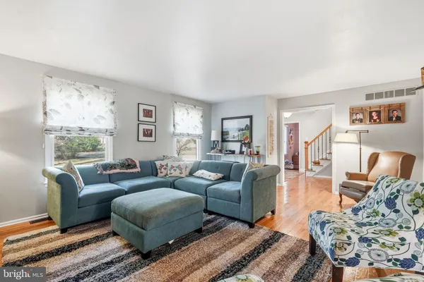 a view of a dining room with furniture wooden floor and chandelier