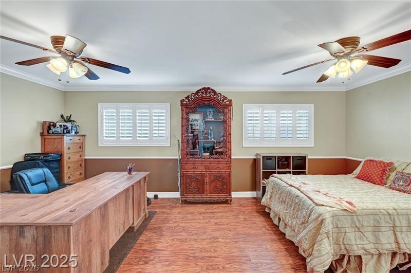 2410 Doherty Way Henderson, NV 89014 - Photo 35 of 63 Bedroom with multiple windows, wood finished floors, ornamental molding, and a ceiling fan