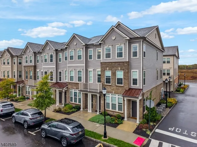 a front view of a residential apartment building with a yard