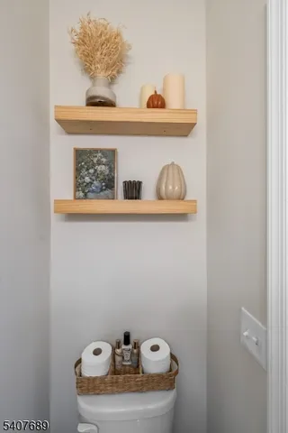 a living room with furniture and a book shelf