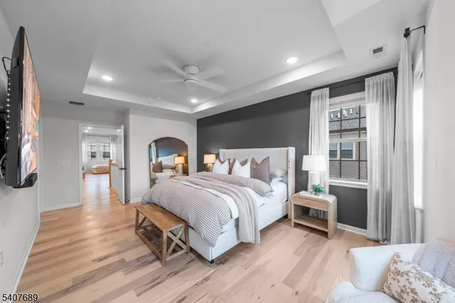 a bedroom with a bed and a chandelier