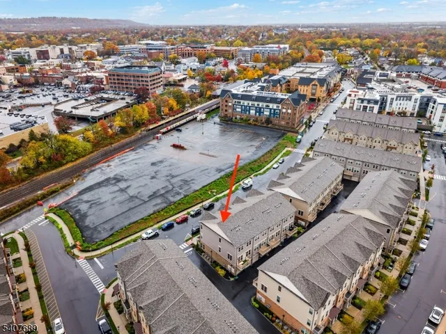 an aerial view of residential houses with outdoor space and city view