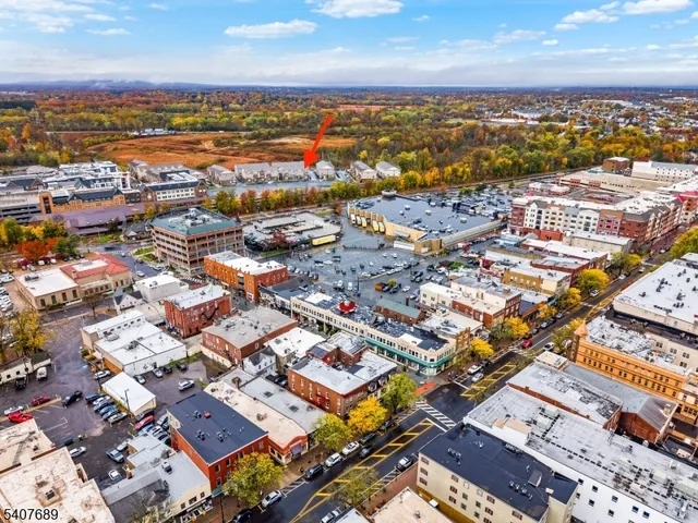 a view of a city that has couple of cars parked in front of it