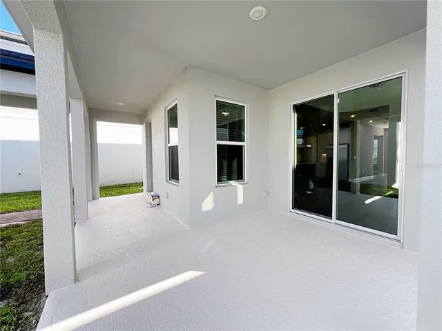 a view of an empty room with glass door and balcony