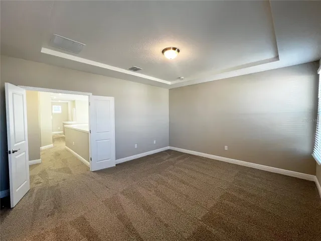 an empty room with mirror and entrance