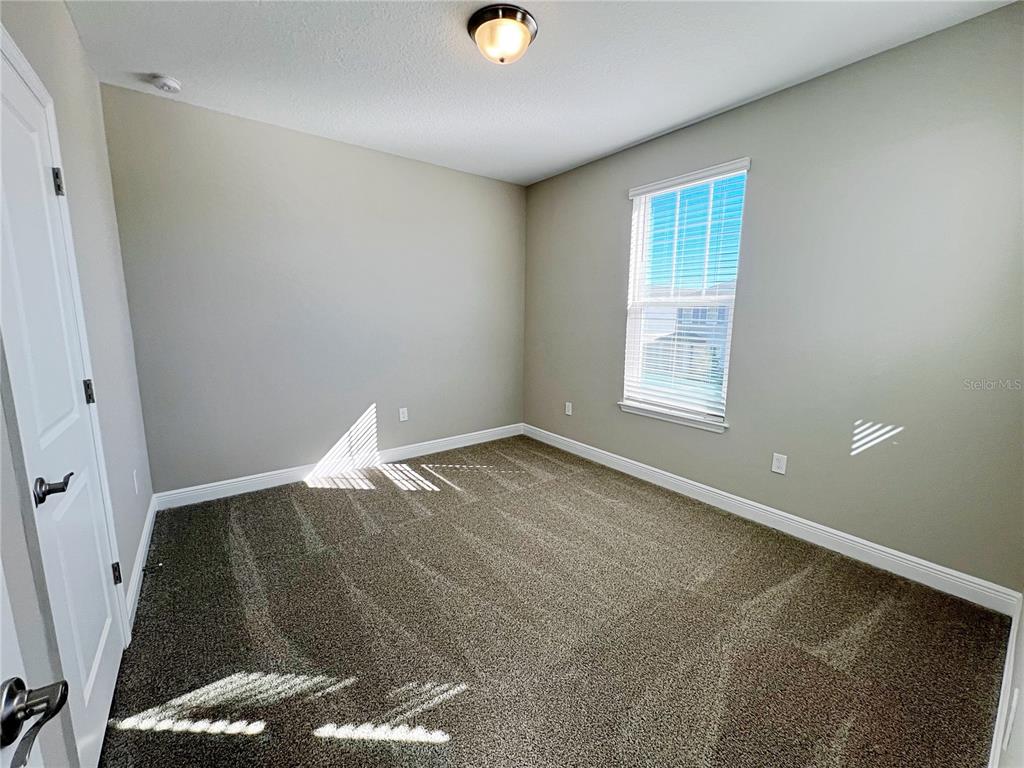 14111 Frasier Street Winter Garden, FL 34787 - Photo 36 of 41 an empty room with wooden floor and windows
