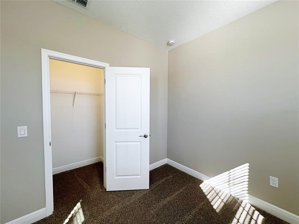 14111 Frasier Street Winter Garden, FL 34787 - Photo 37 of 41 an empty room with wooden floor closet and windows