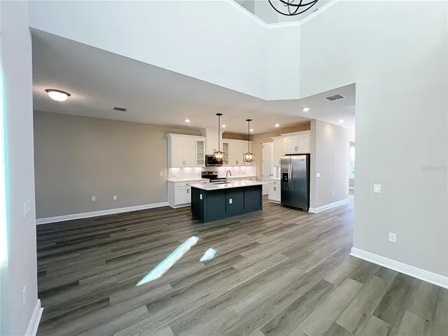 a view of kitchen cabinets and wooden floor