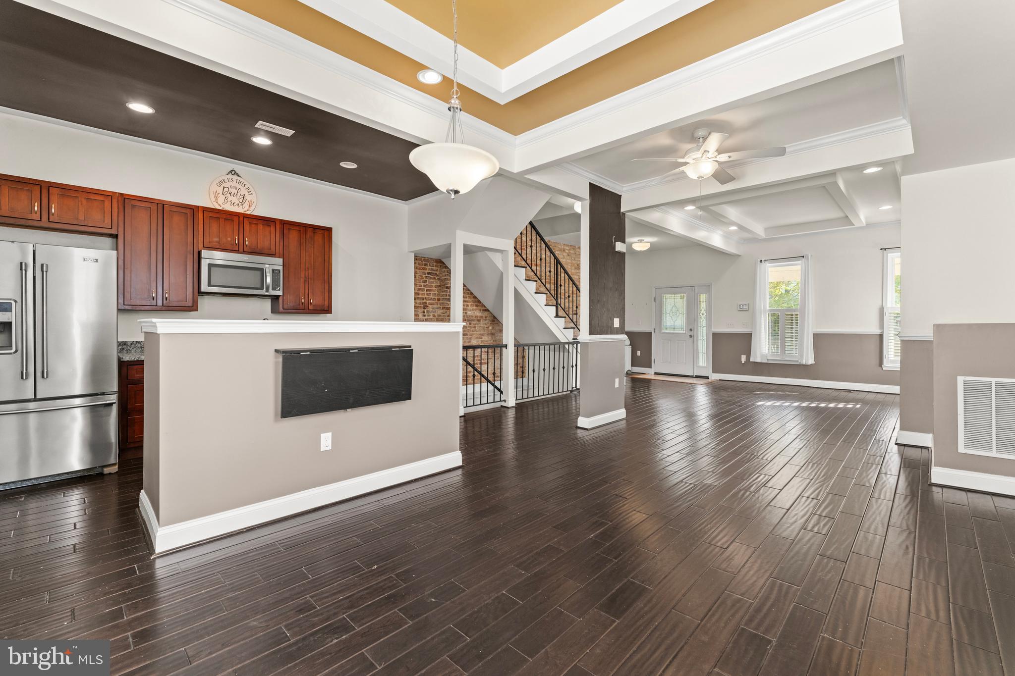 3616 Reisterstown Road Baltimore, MD 21215 - Photo 13 of 34 a view of a kitchen with a refrigerator and wooden floor