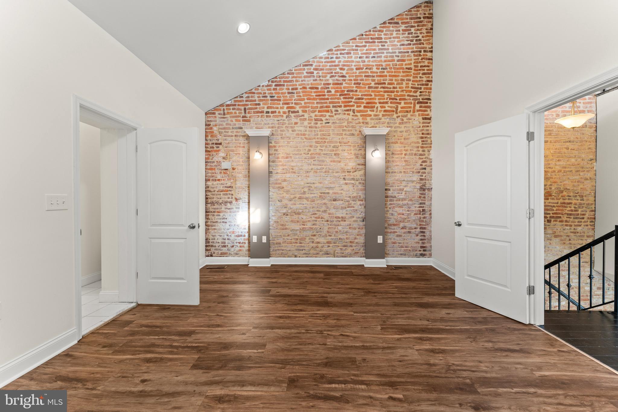 3616 Reisterstown Road Baltimore, MD 21215 - Photo 23 of 34 a view of an empty room with wooden floor and a window