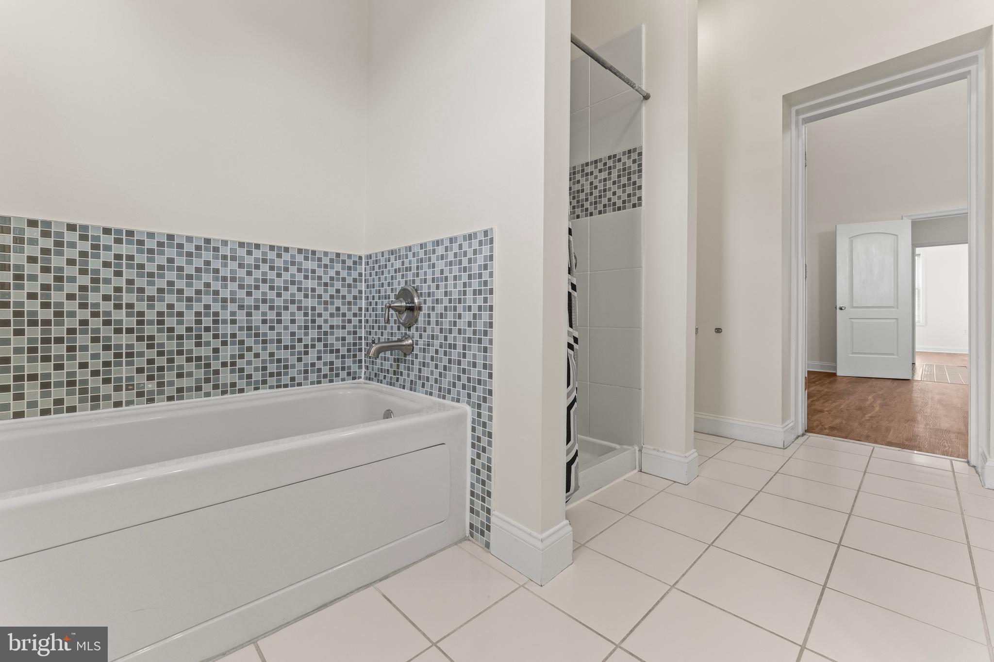 3616 Reisterstown Road Baltimore, MD 21215 - Photo 26 of 34 a bathroom with a bathtub and shower